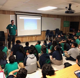 Houston Dentist Addressing Kids in a Classroom