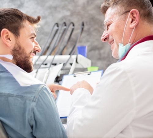 Patient and dental team member discussing insurance coverage